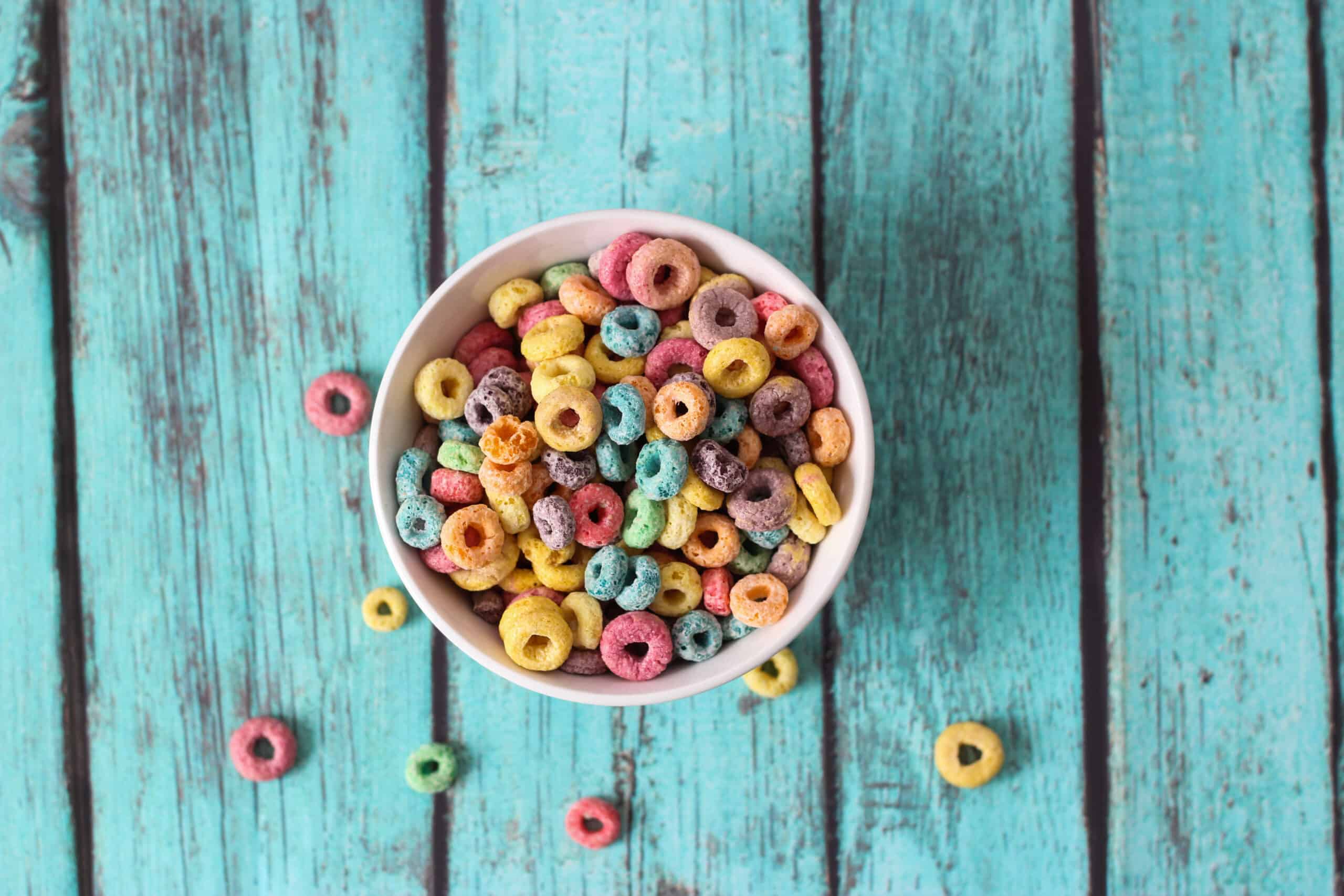 Multicolored,Cereals,In,A,White,Bowl,On,Blue,Background