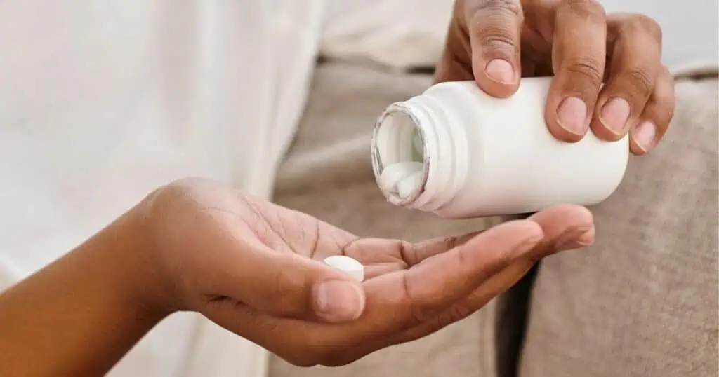 Woman taking trace mineral and electrolyte supplement.