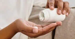 Woman taking trace mineral and electrolyte supplement.