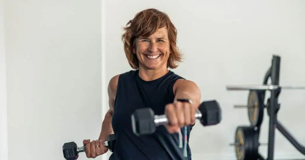 woman lifting weights to prevent bone loss in menopause