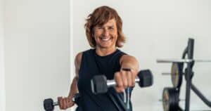 woman lifting weights to prevent bone loss in menopause