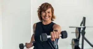 woman lifting weights to prevent bone loss in menopause