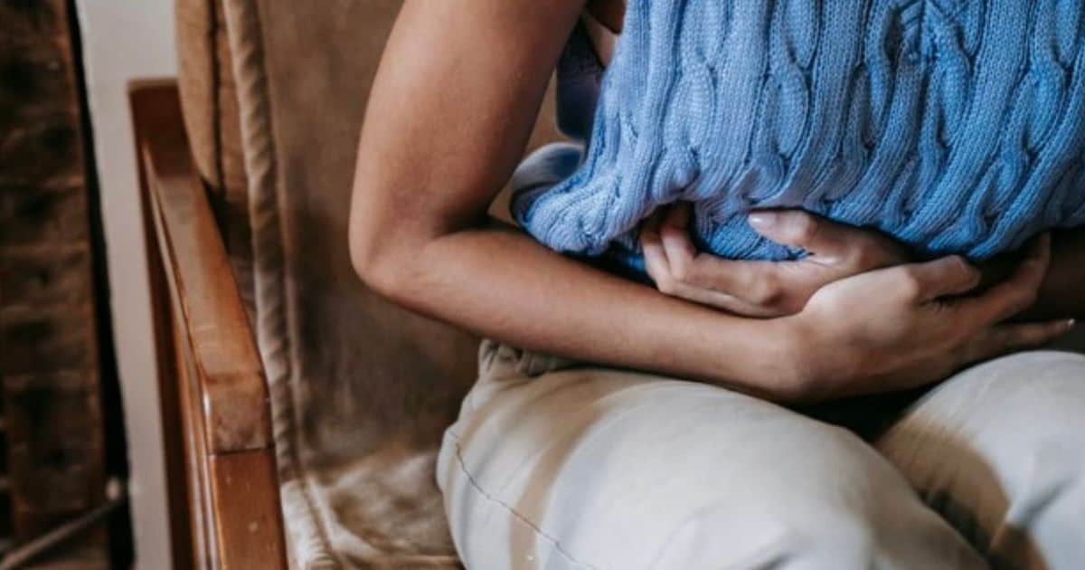 woman holding gut with pain due to celiac gluten exposure